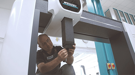 Man calibrating a Wenzel machine