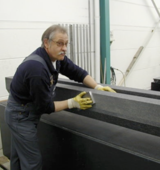 man working on large metal piece