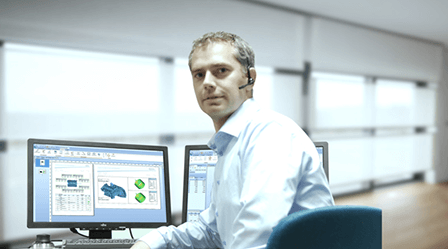 Man with headset sitting at computer